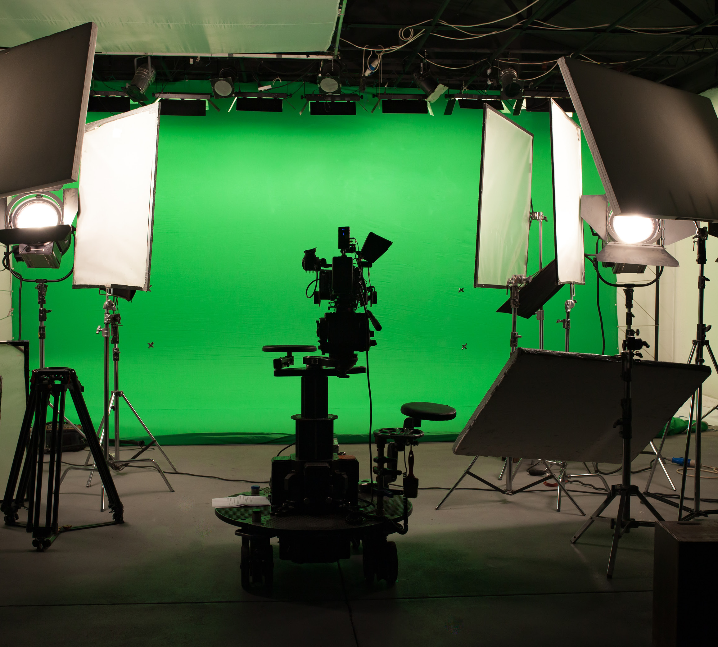 Green screen studio with lighting and film equipment