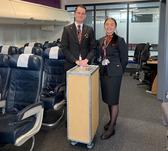 EasyJet Cabin Crew and former students, Sasha and Ethan, using BCoT's flight simulator.