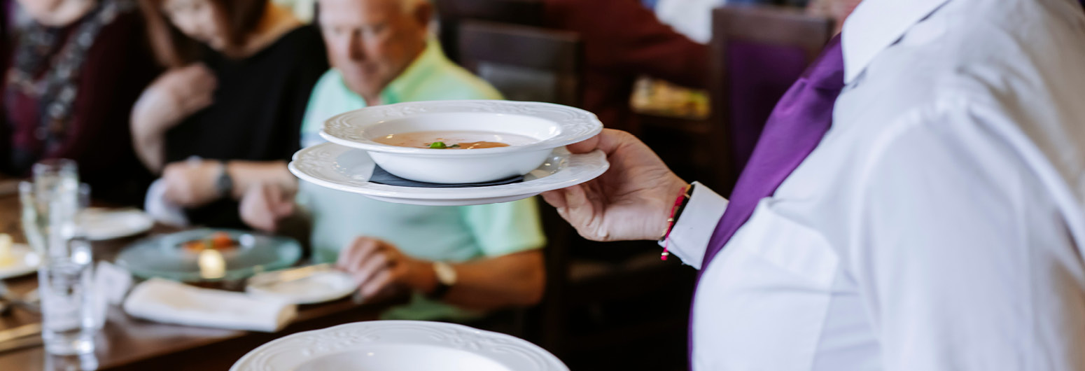 Waitress carrying dishes accross the restaurant
