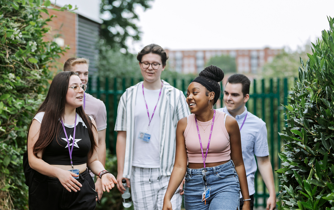 Group Of Students Walking Along Path