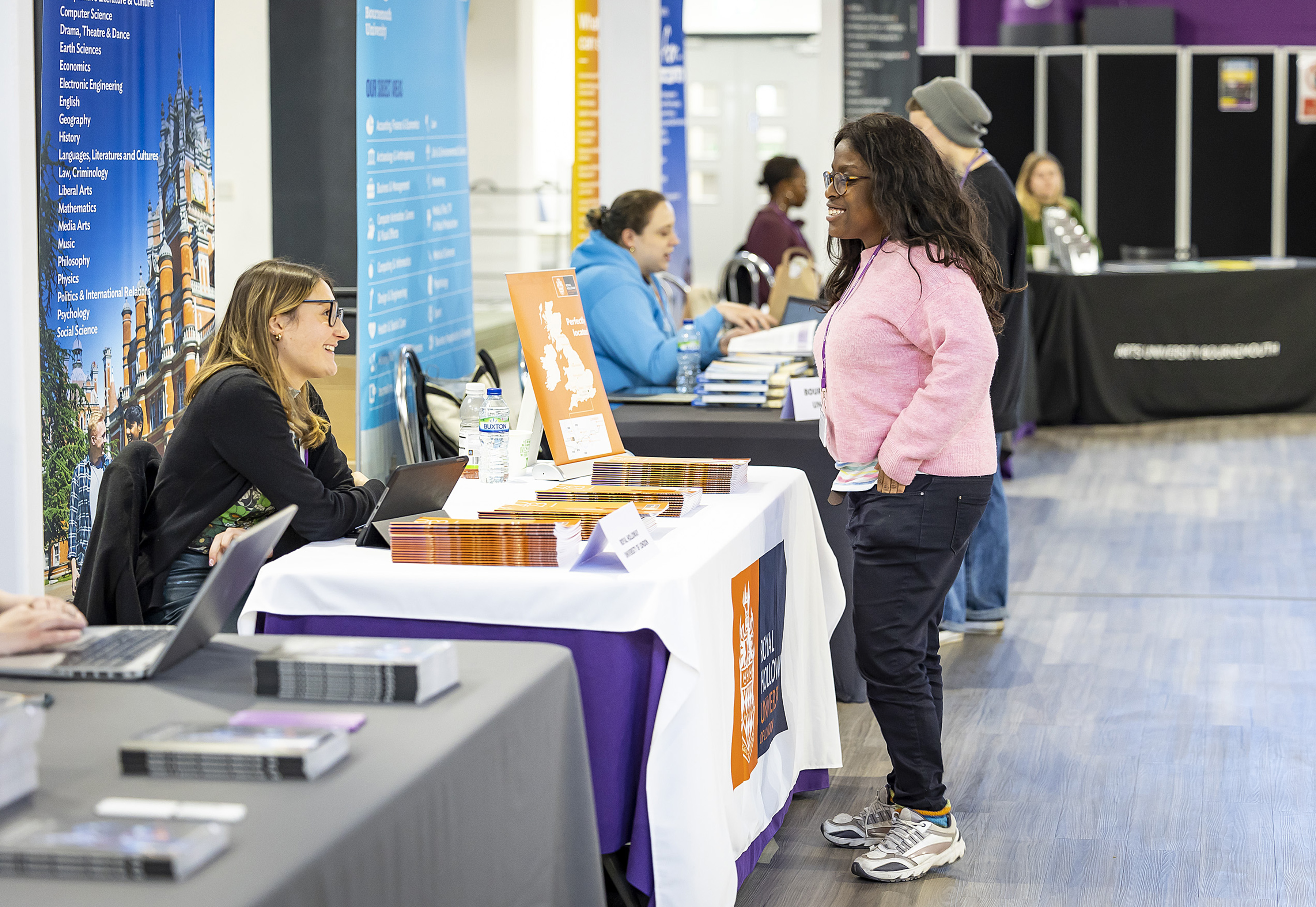 Student chatting to lady at stand