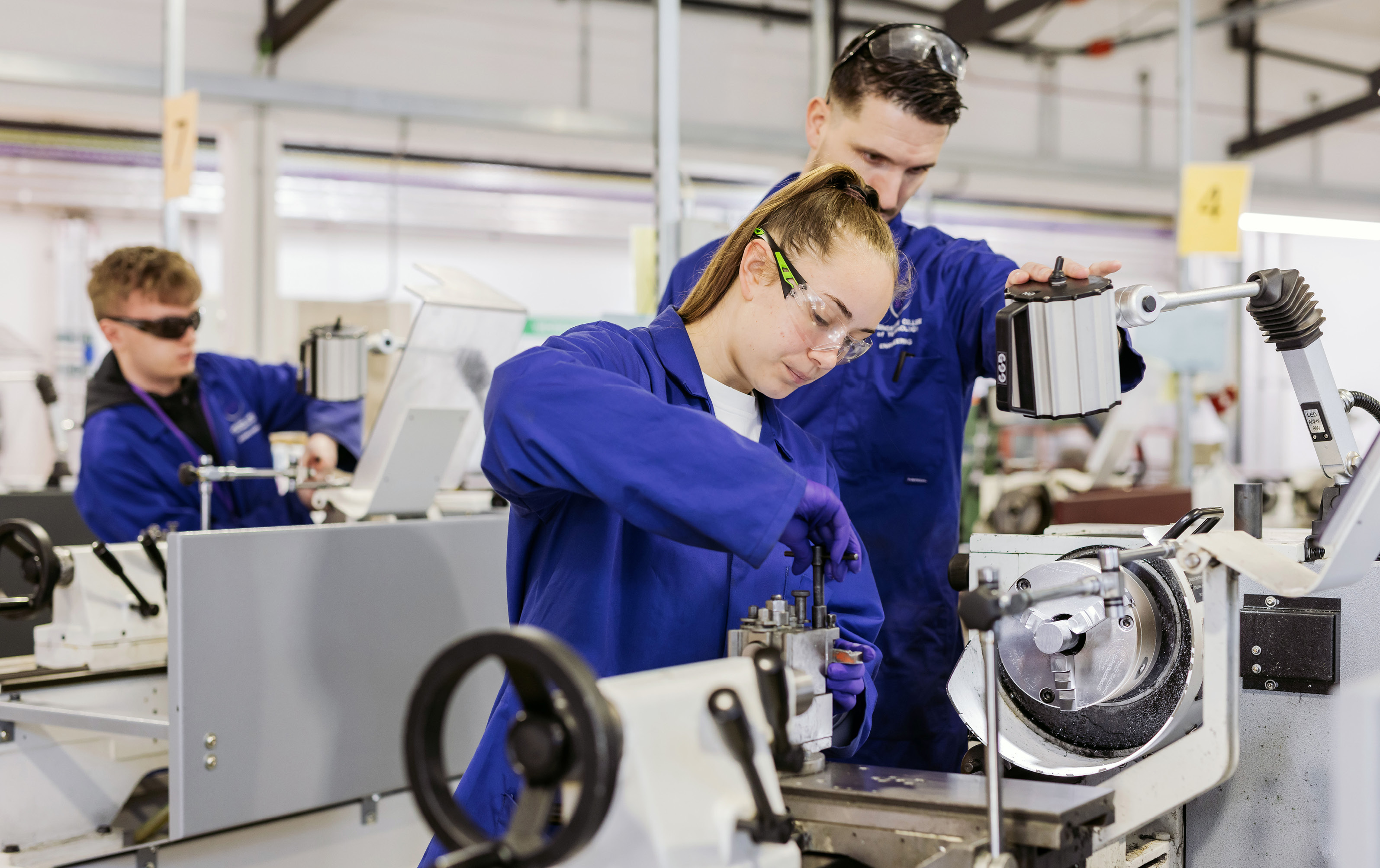 Male lecturer overseeing female student working